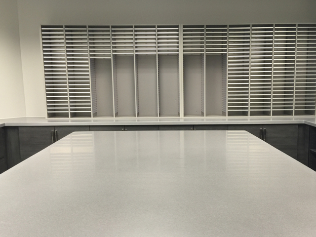 Black and grey laminate Mail Room Casework with Work Island - Solid Surface Casework