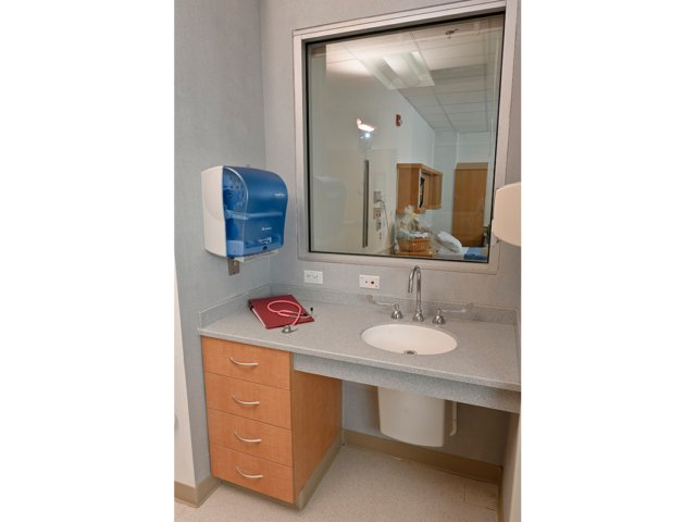 Laminate drawers with a solid surface top supporting a sink - Patient Room - Healthcare Casework