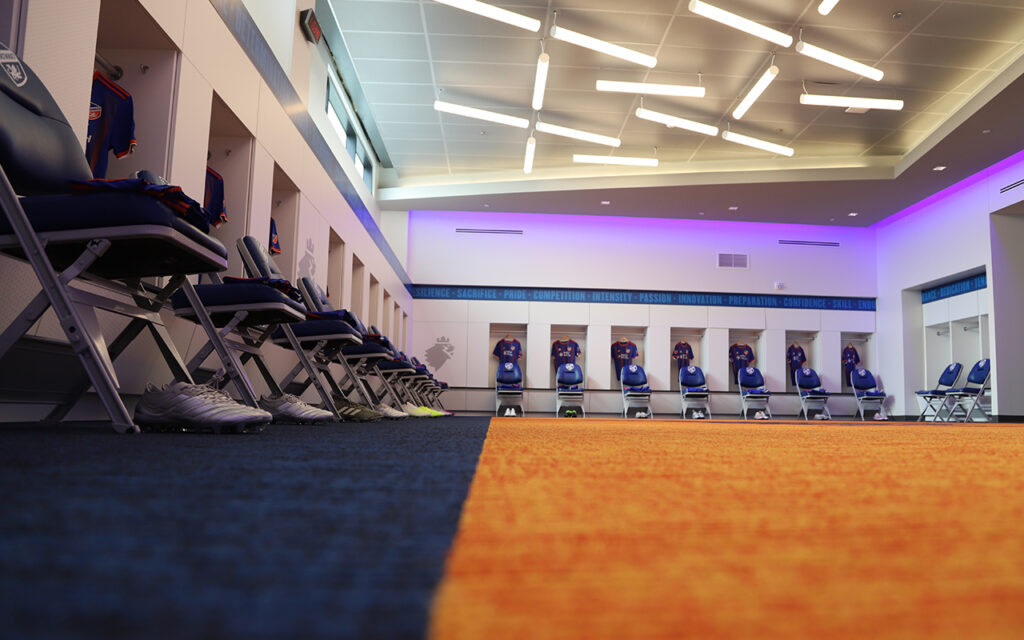 MLS Locker room for FC Cincinnati with custom graphic laminates and bold carpet flooring