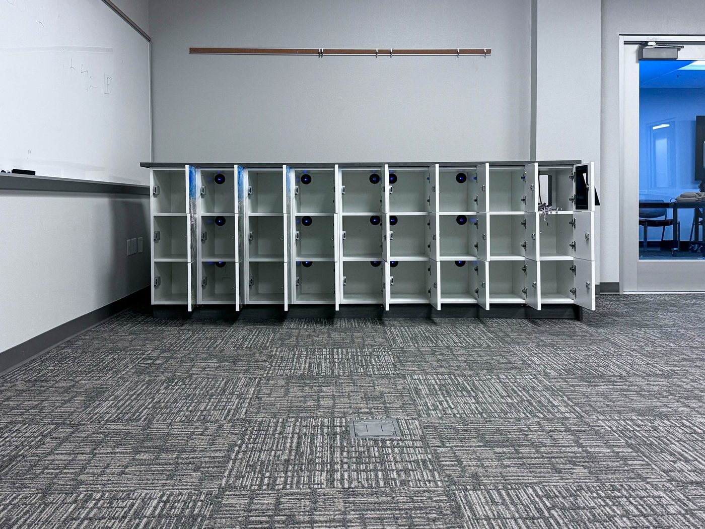 VR headsets stored in Hamilton laminate lockers — University of Redlands XR Lab
